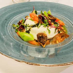 Fresh burrata cheese, grilled tomato, dried figs, and basil vinaigrette